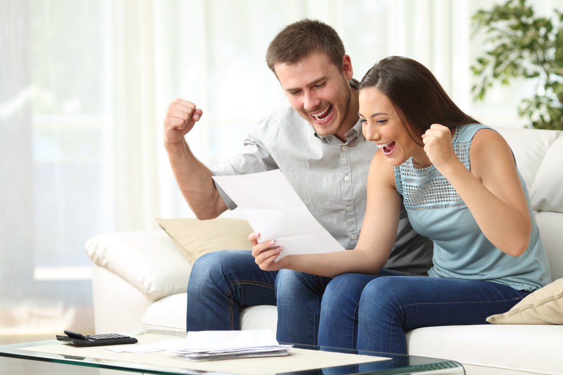 A married couple happy after recieving their Tax returns.